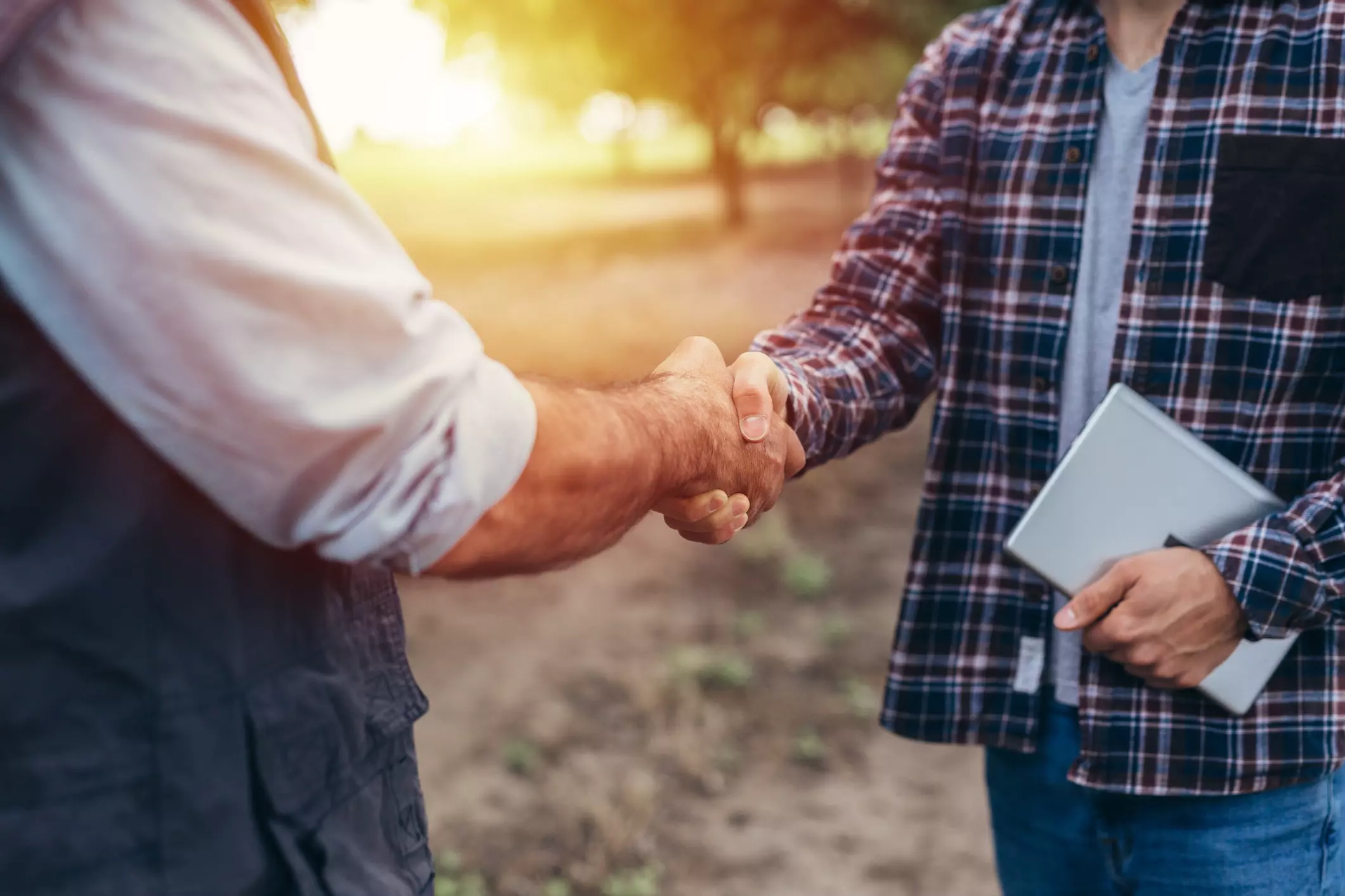 farmers handshake on field